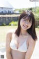 A woman in a white bikini posing for the camera.